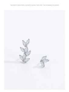 Detailed shot of asymmetrical S925 silver leaf earrings with marquise-cut cubic zirconia
