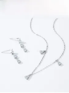 Detailed view of pear-cut sparkling zircon necklace and matching teardrop earrings set