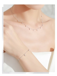 Detail of S925 silver necklace and bracelet set with round cubic zirconia on model