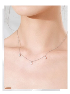 Close-up of S925 sterling silver necklace with three pear-shaped zircons on model