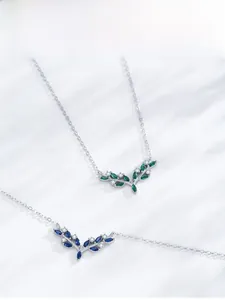 Close-up of 925 sterling silver necklaces with leaf pendants and zircon inlays