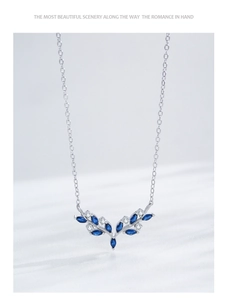 Detailed macro view of S925 silver necklace with blue marquise gems and clear zircons
