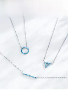 Detailed close-up of S925 silver necklaces with turquoise geometric bar and round pendants