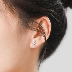 Elegant S925 sterling silver leaf studs with marquise-cut zircon on model's ear
