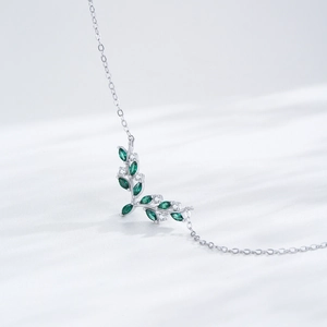 Elegant S925 sterling silver necklace featuring green olive leaf pendant with cubic zirconia