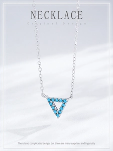 Detailed macro view of S925 sterling silver triangle pendant with turquoise beads