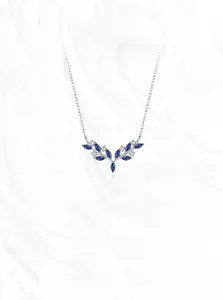 Macro view of 925 silver antler necklace with blue marquise zircon and crystal stones