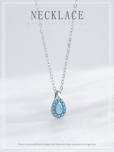 Detailed view of teardrop turquoise pendant on S925 sterling silver chain with halo beads