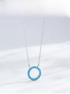 Detailed view of S925 silver necklace with turquoise pavé geometric circular pendant