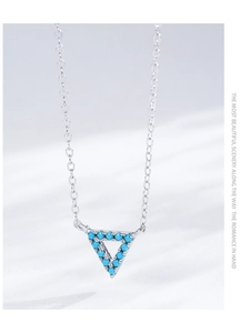 Detailed macro shot of S925 silver necklace with a blue turquoise triangle pendant