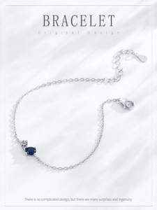 Detail of S925 sterling silver bracelet with blue sapphire stone and lobster clasp