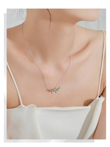 Close-up of 925 sterling silver deer antler necklace with green marquise-cut zircon stones