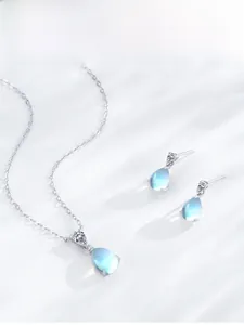 Détail du collier en argent et boucles d'oreilles pierre de lune avec petits diamants