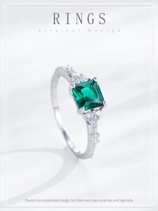 Detailed macro of S925 sterling silver ring with square emerald and side zircon stones
