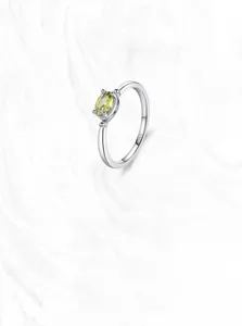Detailed close-up of S925 sterling silver ring with oval olive green gemstone and four claws