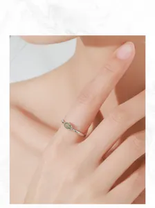 Model wearing a vintage S925 sterling silver ring with an oval olive green gemstone