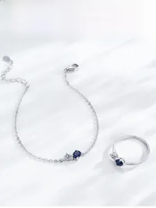 Macro detail of S925 silver jewelry set with blue oval stones and heart crystals