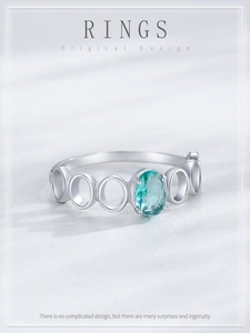 Detailed macro view of S925 silver ring featuring an oval Paraiba blue gemstone and hollow band