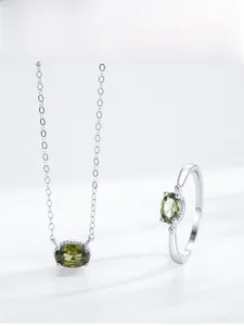 Detail view of S925 sterling silver set with oval olive green gemstones and four-claw setting