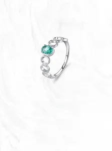 Detailed macro view of S925 sterling silver ring with oval green gemstone and hollow band