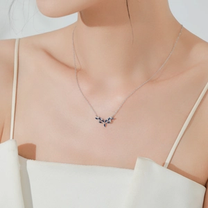 925 silver deer antler necklace with deep blue zircon worn by a model in elegant style