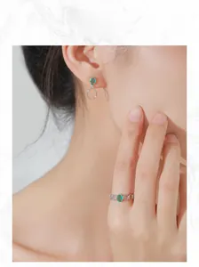 Model wearing S925 silver jewelry set with oval green gemstones and chain ring