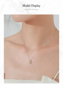 Close-up of a pear-cut yellow gemstone necklace in S925 silver on a female model