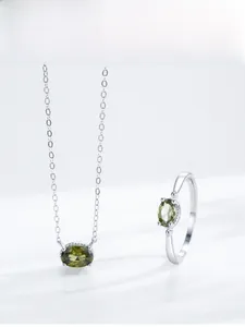 Detail shot of S925 silver necklace and ring set with oval olive green gemstones