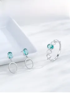 Detailed macro view of S925 sterling silver jewelry set with oval green emerald gemstones