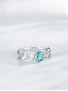 Detail of S925 silver ring featuring an oval green gemstone and hollow geometric band