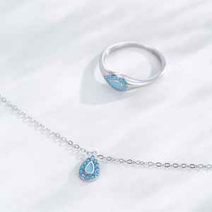 S925 silver water drop necklace and ring set with turquoise accents on white surface