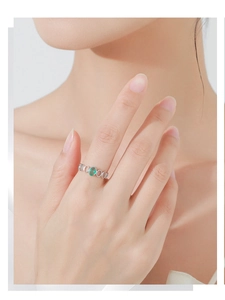 Macro view of S925 sterling silver ring with oval green gemstone and hollow circle band