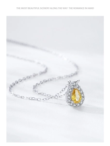 Detailed view of pear-cut yellow gemstone necklace with white pavé halo in S925 silver