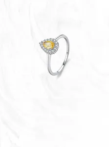 Macro shot of S925 silver ring featuring a pear-cut yellow gemstone with halo diamonds