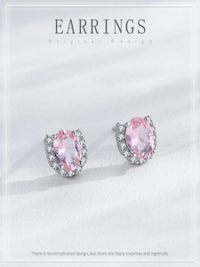 Detail of S925 silver stud earrings with oval pink stone and white crystal border