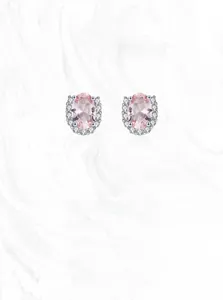 Macro view of S925 silver stud earrings with pink oval stone and U-shaped halo detail