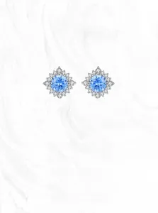 Detailed macro view of S925 silver sunflower stud earrings with blue gemstone and diamonds