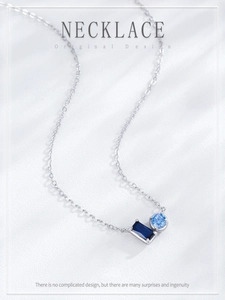 Detail of S925 silver necklace with rectangular dark blue and round light blue zircon stones