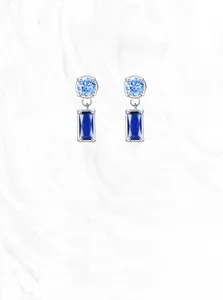 Detail view of S925 silver earrings with round sky blue and rectangular deep blue sapphire stones