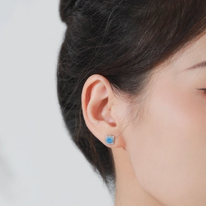 Elegance S925 silver sunflower earrings featuring sky blue center stone with halo setting
