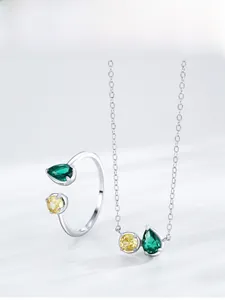 Detail of S925 sterling silver set featuring pear-cut emerald and yellow zircon