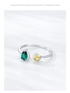 Detail of S925 silver open ring with green pear-cut and yellow round-cut zircon stones