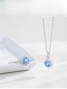 Detail shot of S925 silver ring and necklace set with blue flower-shaped gemstones