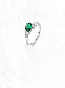 Detailed close-up of S925 sterling silver ring with oval green emerald zircon
