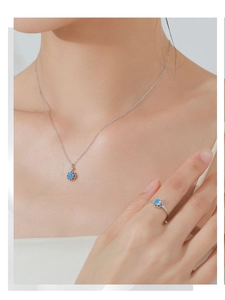 Macro view of S925 silver flower necklace and ring set with blue crystal stones