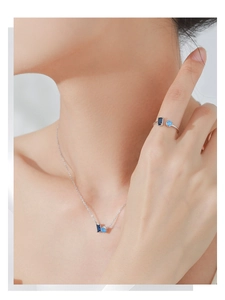 Close-up of S925 sterling silver set with rectangular and round blue cubic zirconia stones