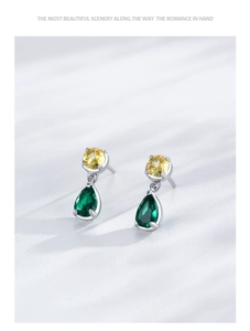 Detailed view of S925 silver earrings with yellow and drop-shaped green zircon crystals