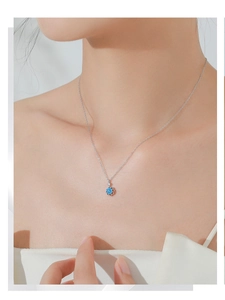 Close-up of S925 silver necklace with blue floral gemstone pendant worn by a model