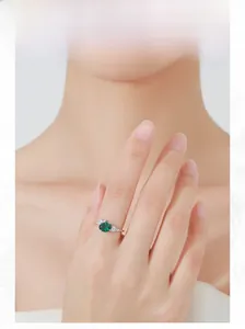Elegantly worn silver ring featuring oval emerald-cut stone and marquise diamond accents