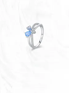 Detailed macro view of S925 silver ring featuring blue teardrop stones and bow design